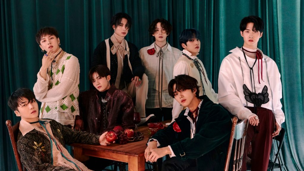 PENTAGON posing over a dark teal curtain for their INVITE:U album.