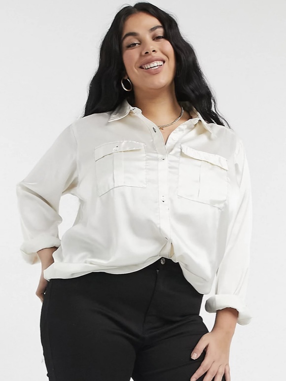 A white long-sleeved button shirt with double breast pockets.