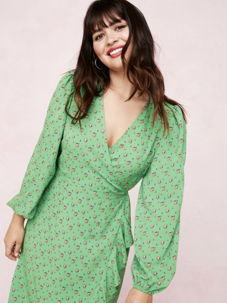 A long-sleeved plus size green long dress with floral patterns.