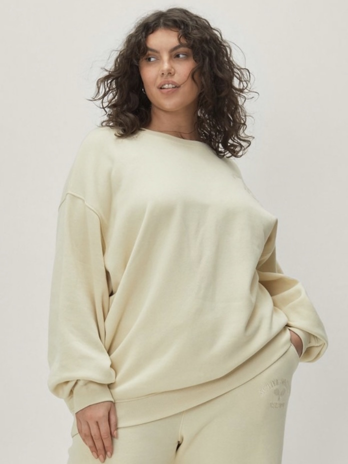 An ivory long-sleeved plus-size sweatshirt.