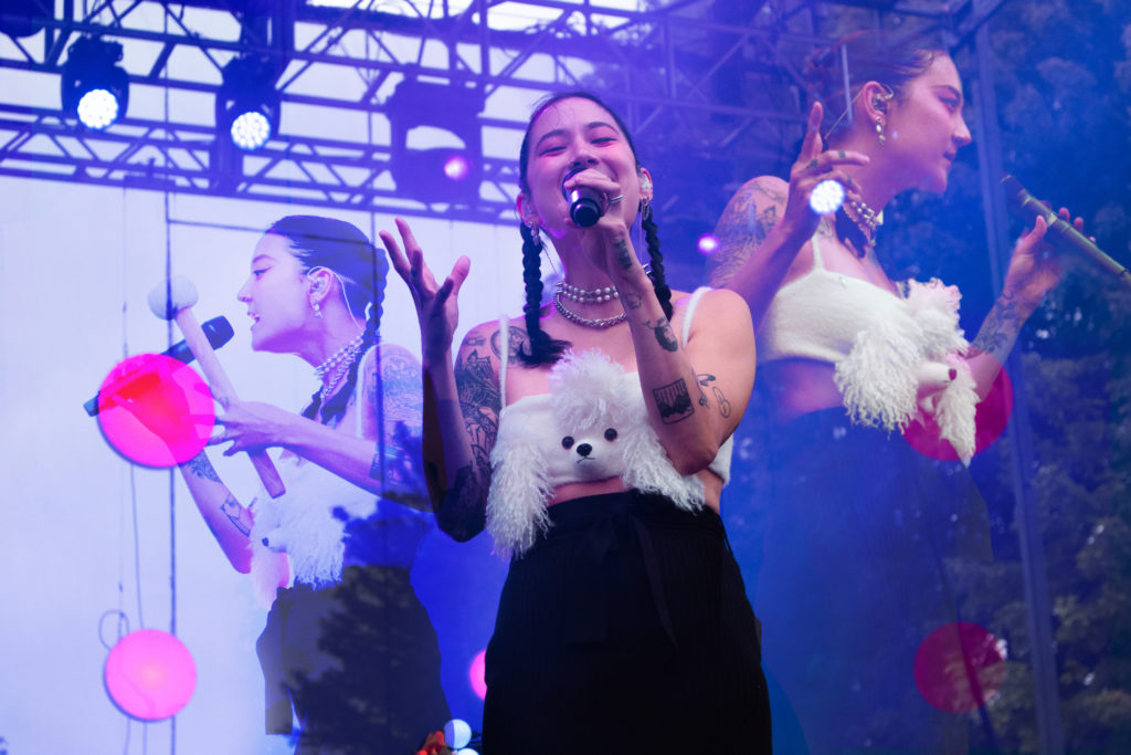 Left and right pictures: Japanese Breakfast performing at the 2022 Pitchfork Music Festival.