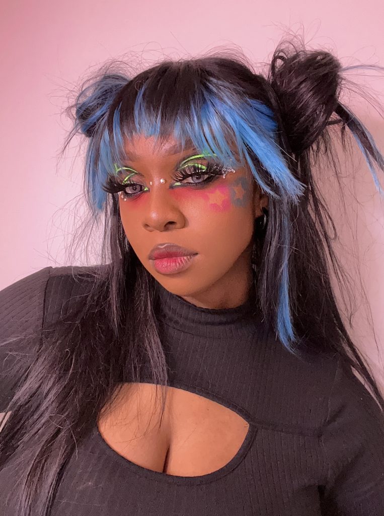 Close up of Kryscy, a Black person in a makeup look inspired by NCT 127's Neo Seoul Nightclub. 