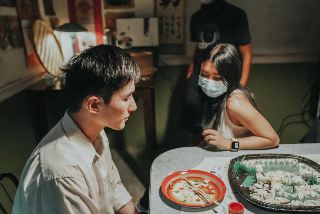 Kelly Yu and an actor at the scene of Plum Town (2020).