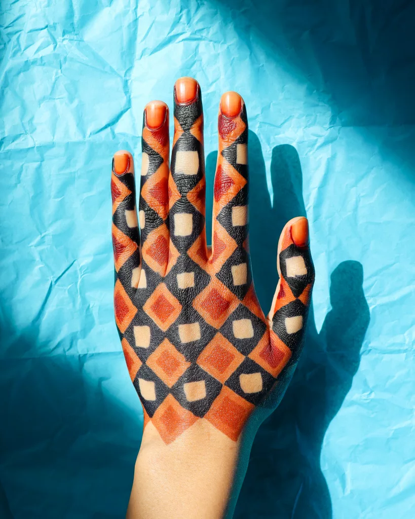 Henna art in red, orange, and black