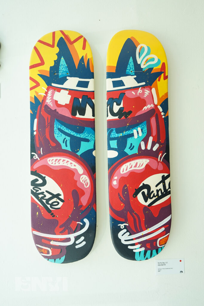 A painting done in a set of two skateboards.