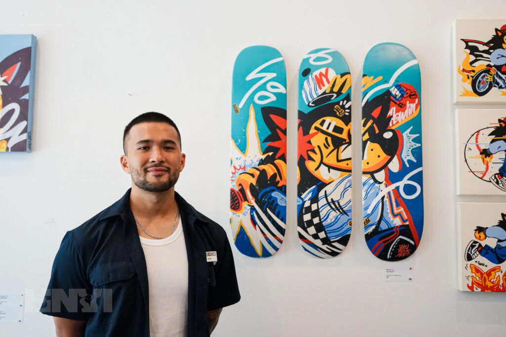 Jappy Agoncillo posing next to one of his artworks