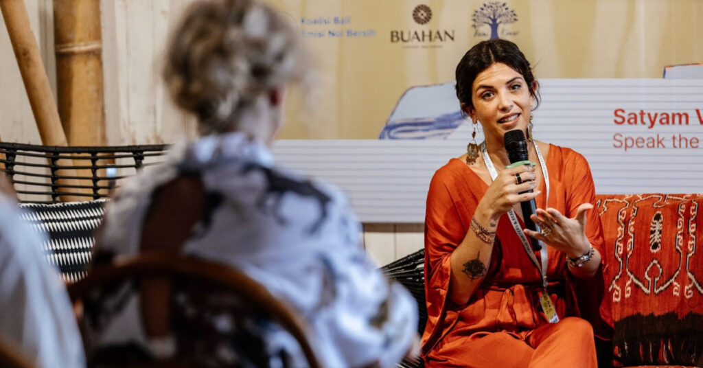 A woman speaking at a panel.